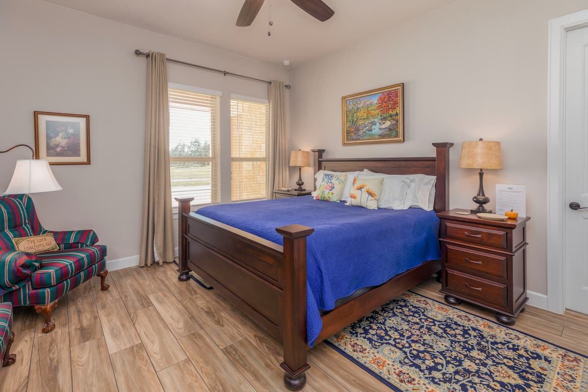 Wildflower room: king bed with blue bedding and solid wood Amish furnishings